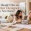 Interior designer discussing home interior plans, material samples, and design ideas with homeowners in a modern living room.